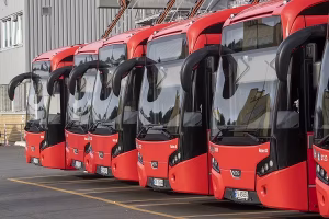 line of six electric buses charging with Tenix charge technology