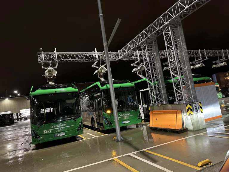 two green buses from Kolumbus at charging station - Tenix Fleet management