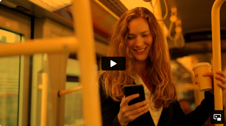 Happy woman checking her phone in a bus