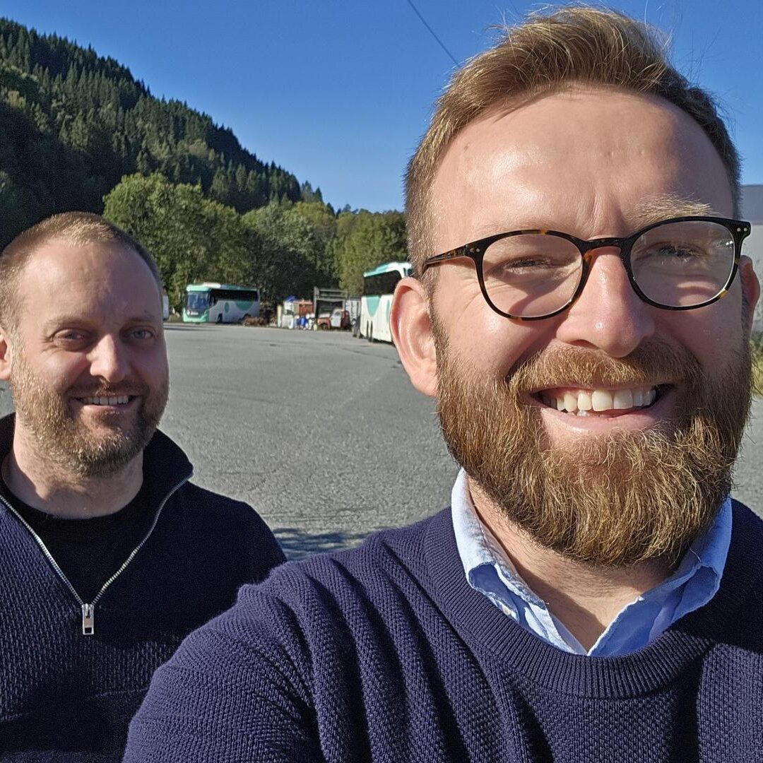 Tenix Value: People Come First Two Tenix team members smiling outdoors, representing the company value of People Come First.